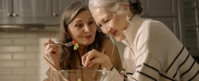 2 women sharing a salad.